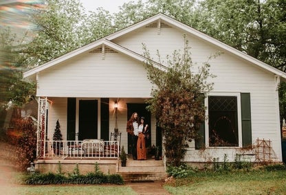 Historic bungalow with charming couple standing on porch, Hyde Park, Austin