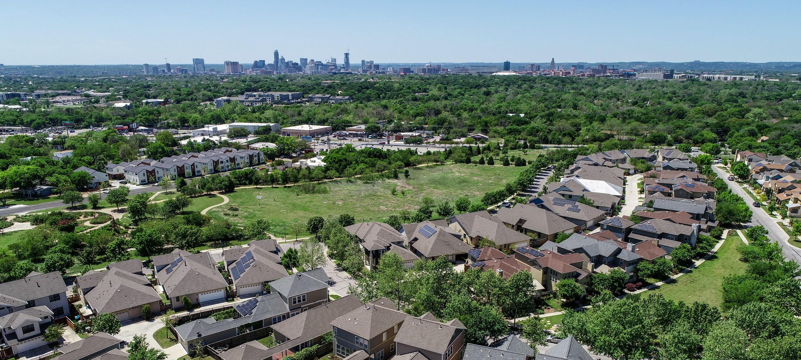 Aerial view of Mueller residential neighborhood with Austin skyline